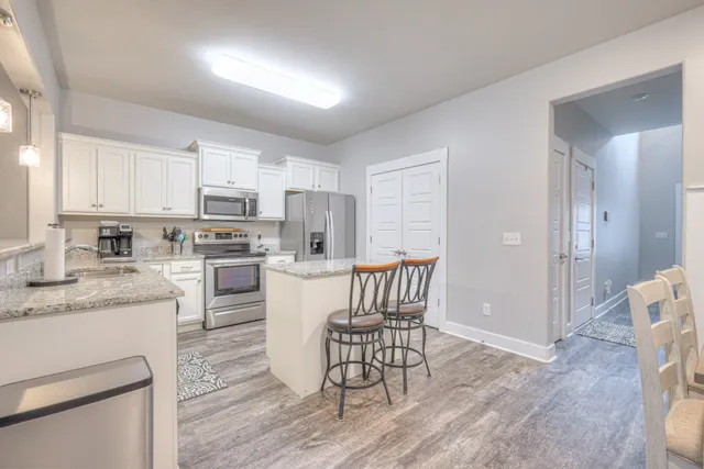 a kitchen with white cabinets and stainless steel appliances