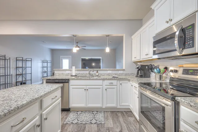 a kitchen with a sink stove and cabinets