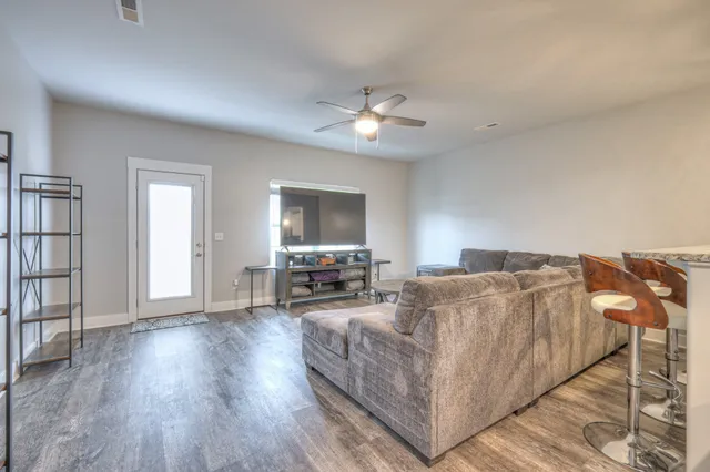 a living room with furniture and a chandelier