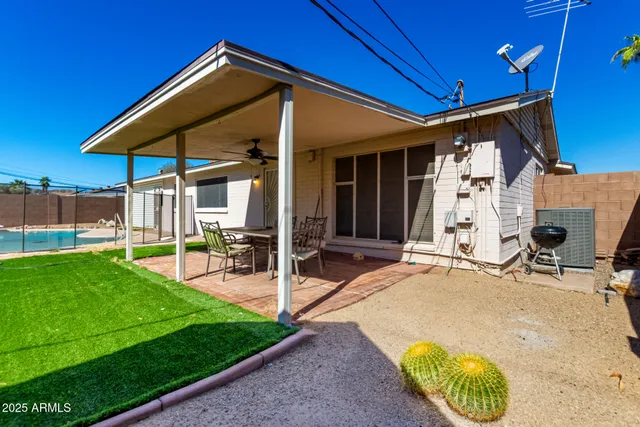 a view of a house with backyard and porch