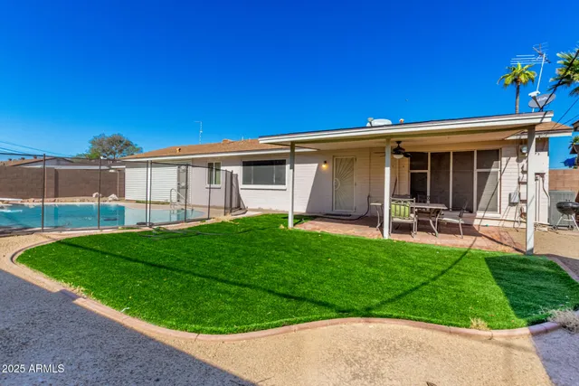a view of a house with backyard and porch