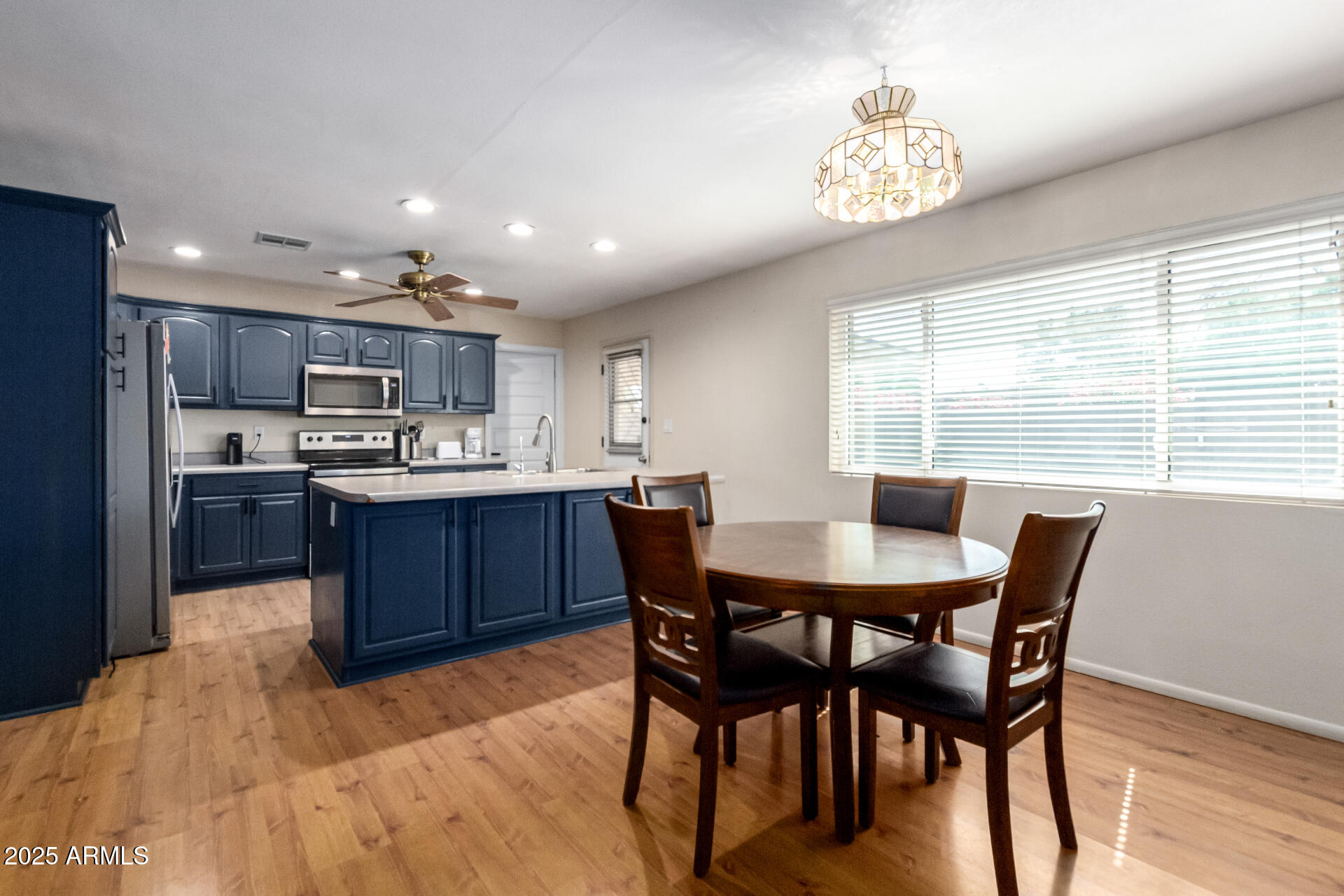 3045 East Cholla Street Phoenix, AZ 85028 - Photo 5 of 23 a kitchen with a dining table chairs and refrigerator