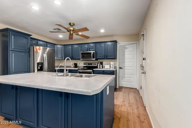 a kitchen with stainless steel appliances a refrigerator sink and microwave