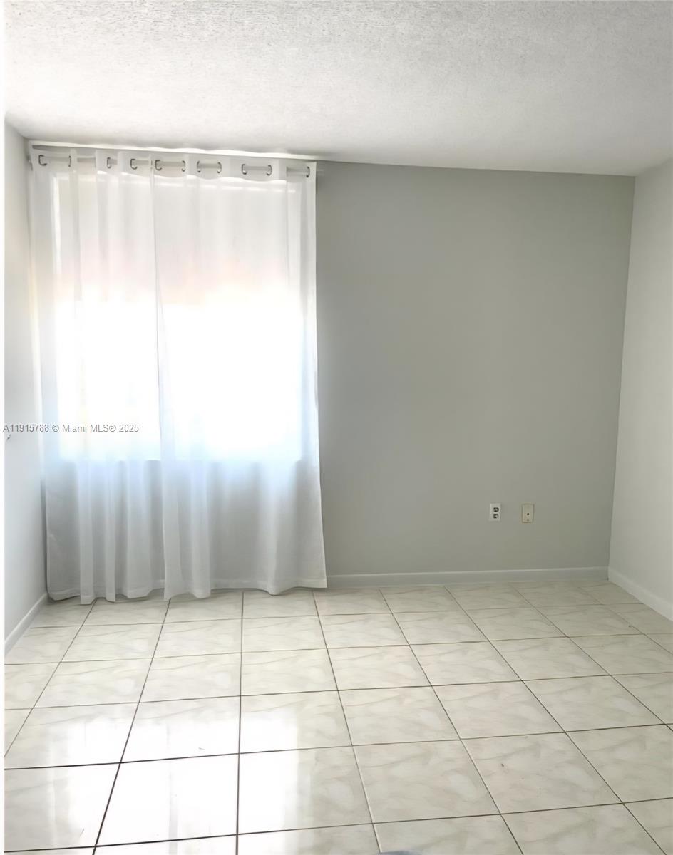 250 180th Drive, Unit 510 Sunny Isles Beach, FL 33160 - Photo 11 of 19 a view of an empty room with a window