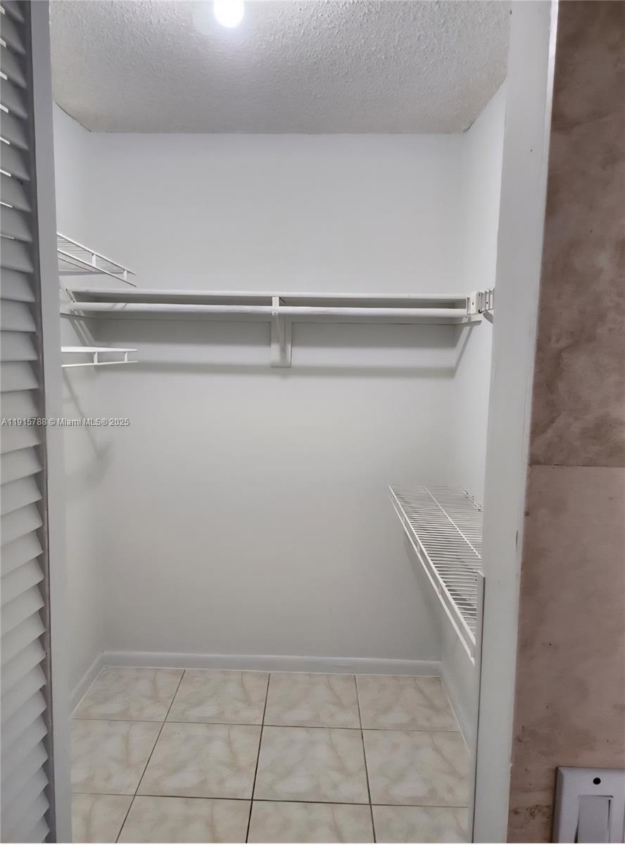 250 180th Drive, Unit 510 Sunny Isles Beach, FL 33160 - Photo 13 of 19 a view of closet with racks on the wall