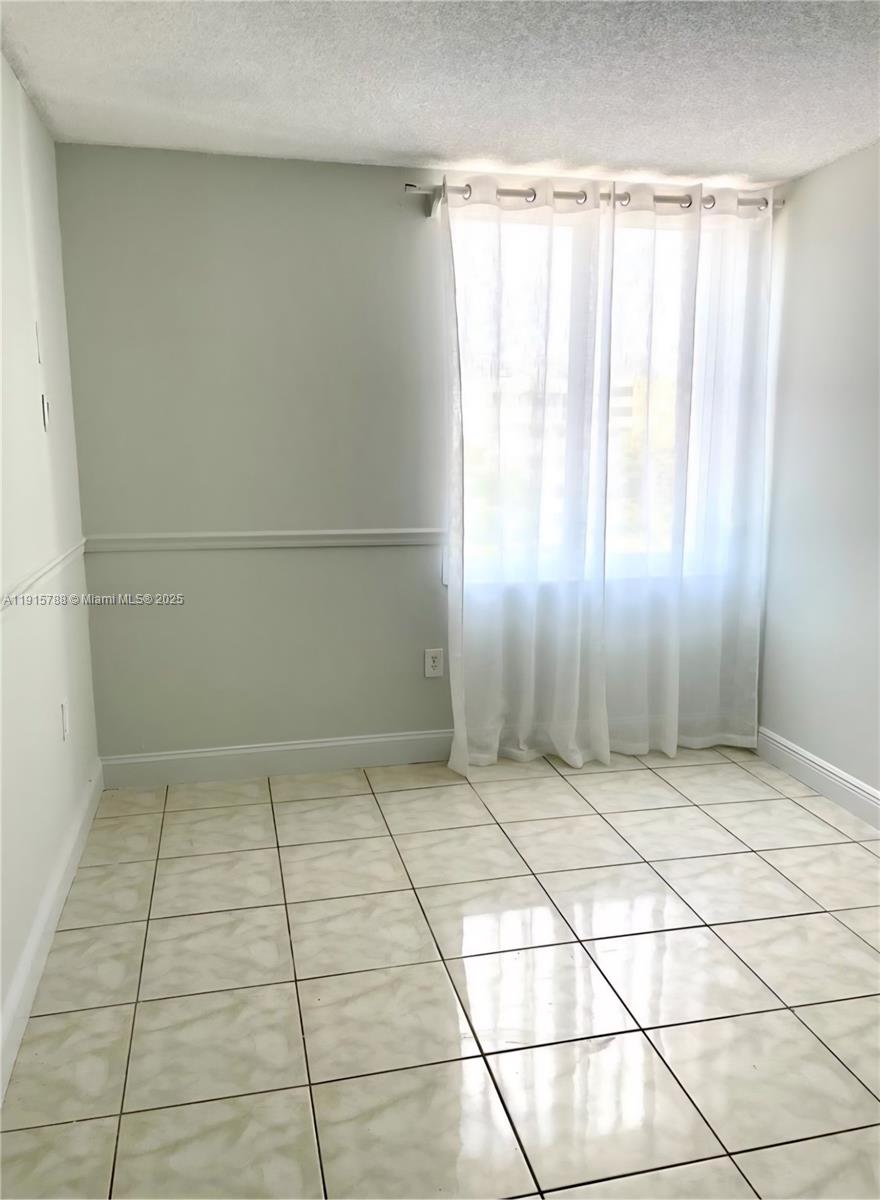 250 180th Drive, Unit 510 Sunny Isles Beach, FL 33160 - Photo 17 of 19 a view of an empty room and window