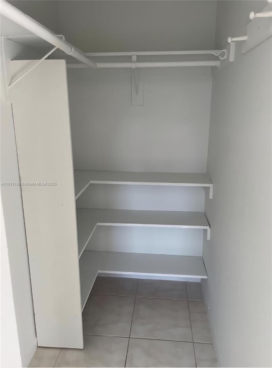 250 180th Drive, Unit 510 Sunny Isles Beach, FL 33160 - Photo 19 of 19 a view of walk in closet with empty racks