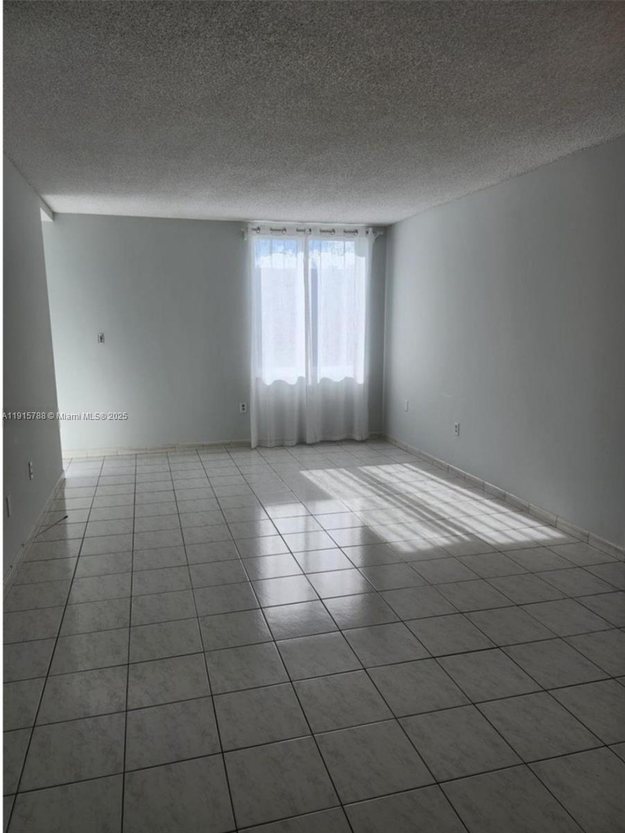 250 180th Drive, Unit 510 Sunny Isles Beach, FL 33160 - Photo 4 of 19 a view of an empty room and window