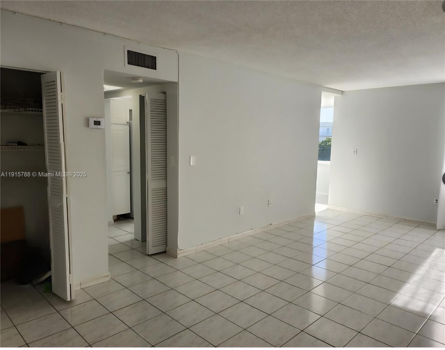 250 180th Drive, Unit 510 Sunny Isles Beach, FL 33160 - Photo 5 of 19 an empty room with windows
