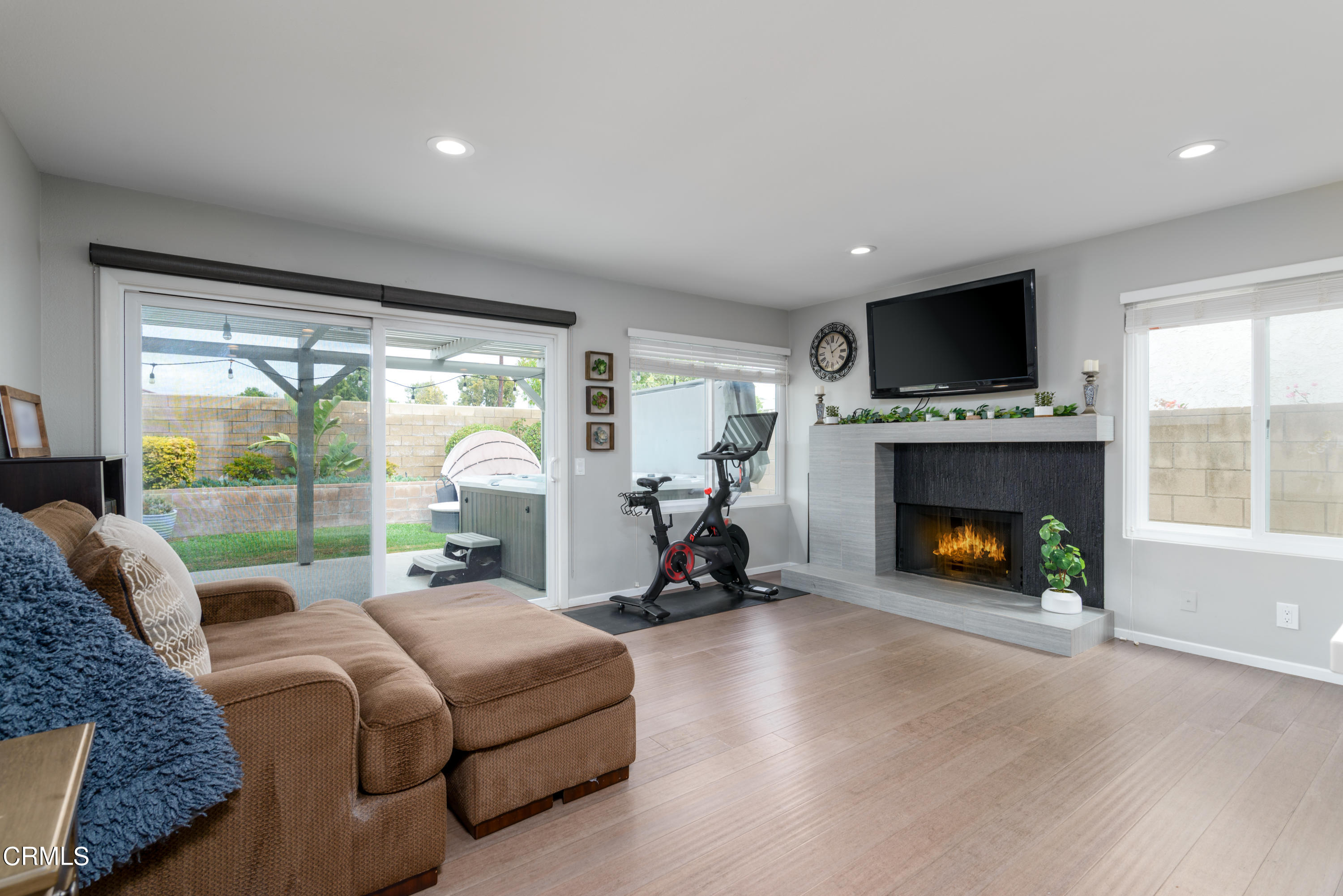 4274 Peach Slope Road Moorpark, CA 93021 - Photo 11 of 27 a living room with furniture large windows and a fireplace