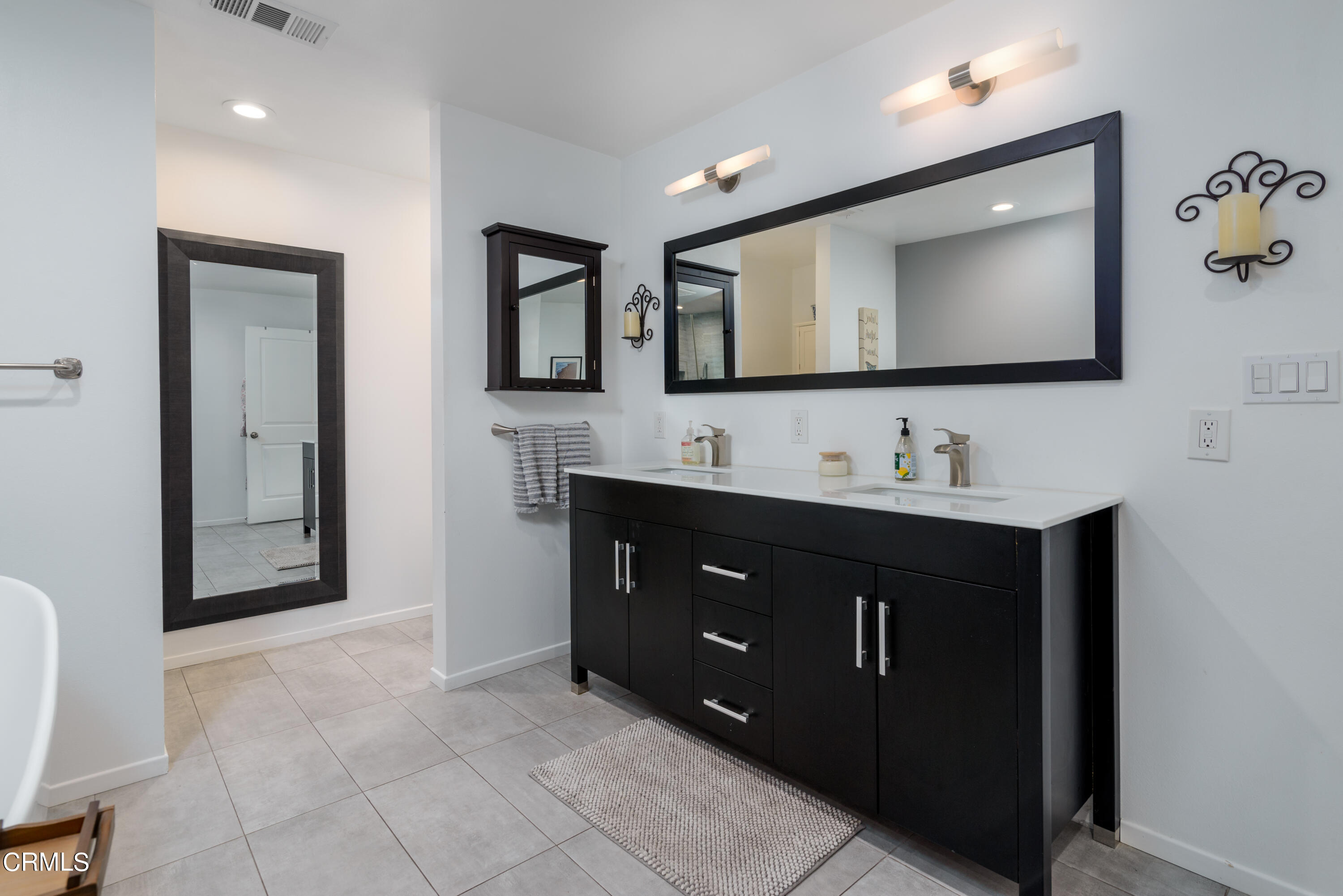 4274 Peach Slope Road Moorpark, CA 93021 - Photo 18 of 27 a bathroom with a vanity a sink a mirror and a vanity