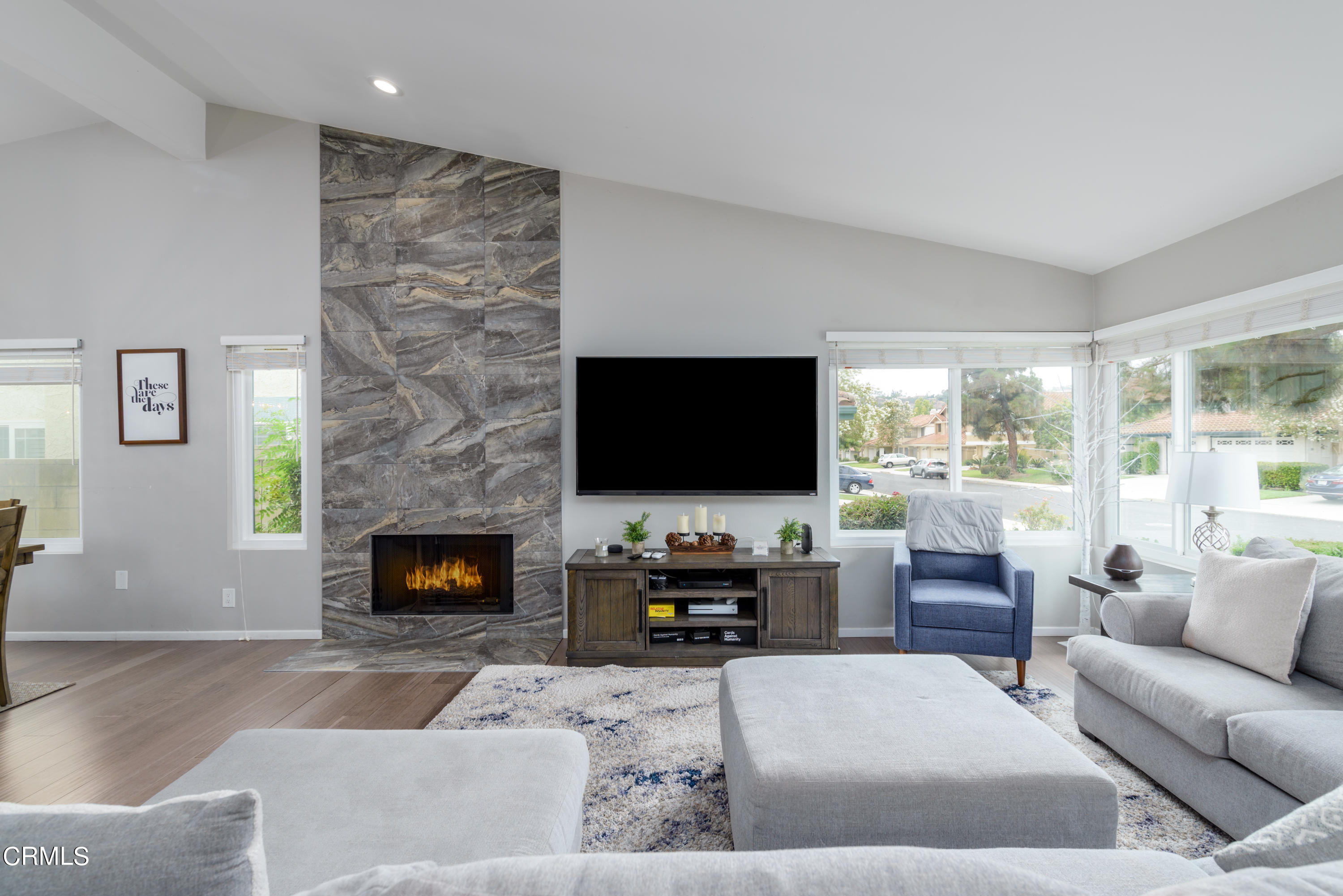 4274 Peach Slope Road Moorpark, CA 93021 - Photo 3 of 27 a living room with furniture a flat screen tv and a fireplace