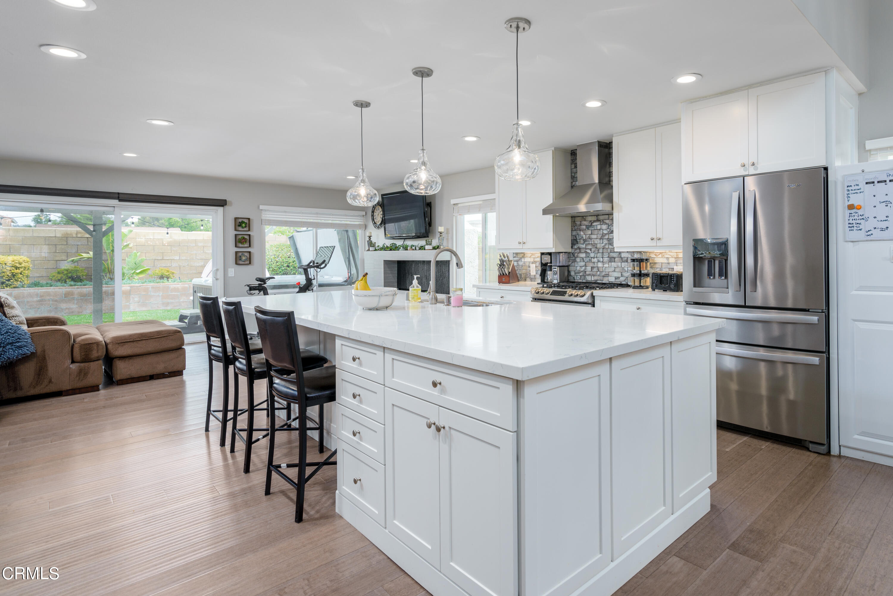 4274 Peach Slope Road Moorpark, CA 93021 - Photo 6 of 27 a kitchen with stainless steel appliances kitchen island granite countertop a table chairs and a refrigerator