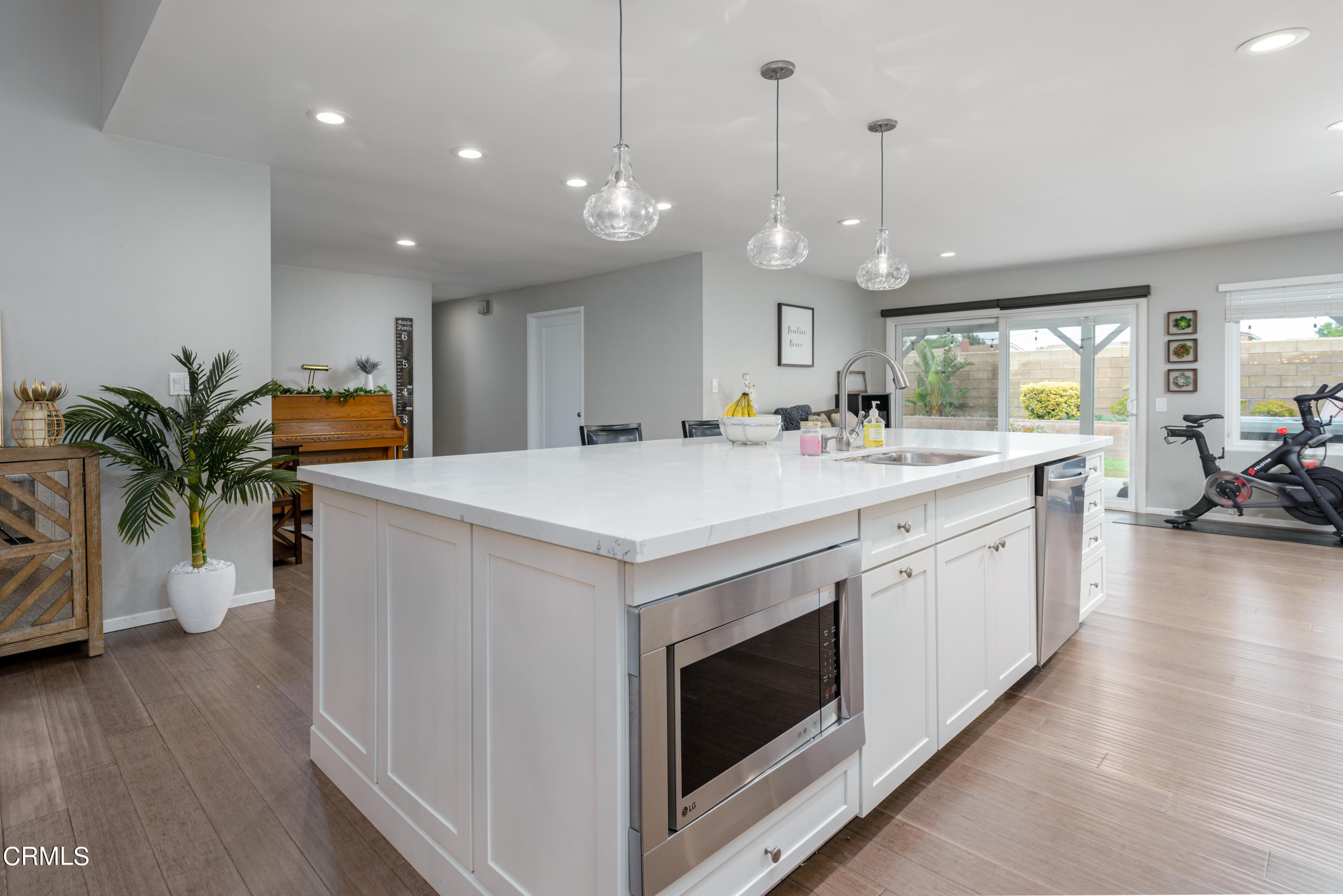 4274 Peach Slope Road Moorpark, CA 93021 - Photo 7 of 27 a kitchen with stainless steel appliances kitchen island a large island in the center
