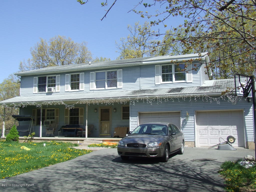 104 Blueberry Hill Road Bushkill, PA 18324 - Photo 1 of 1 a front view of a house with a garden