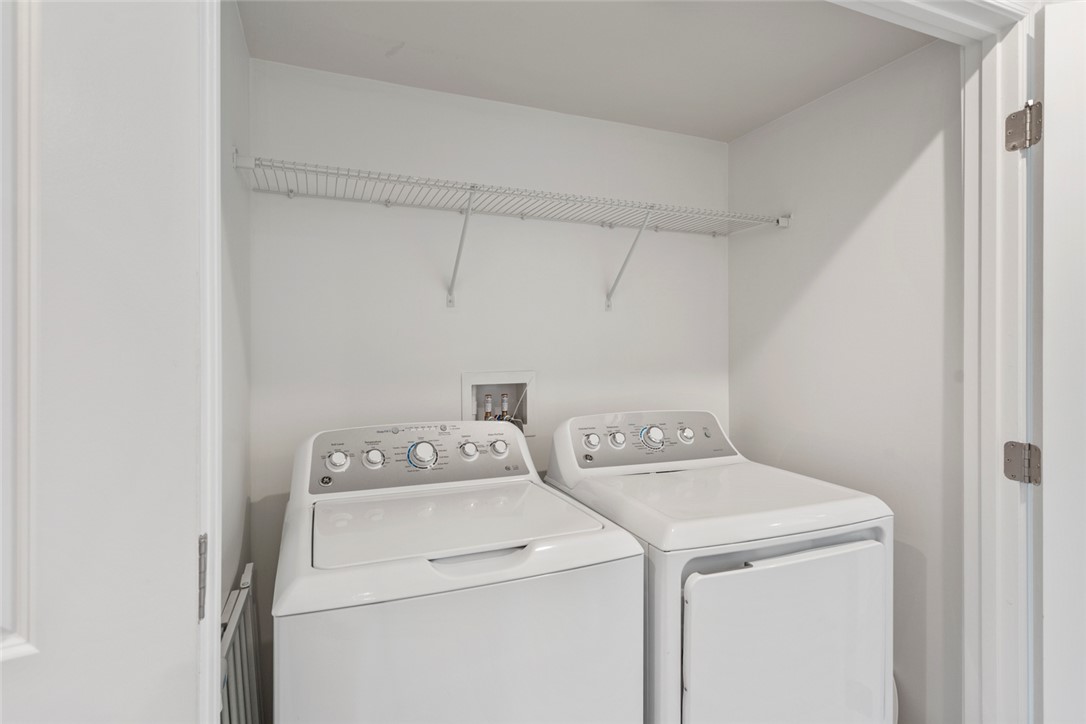 137 Nicklaus Drive Anderson, SC 29621 - Photo 32 of 37 A well-appointed laundry area, thoughtfully designed for efficiency with contemporary appliances and overhead storage.