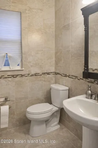 a white toilet sitting next to a bathroom sink