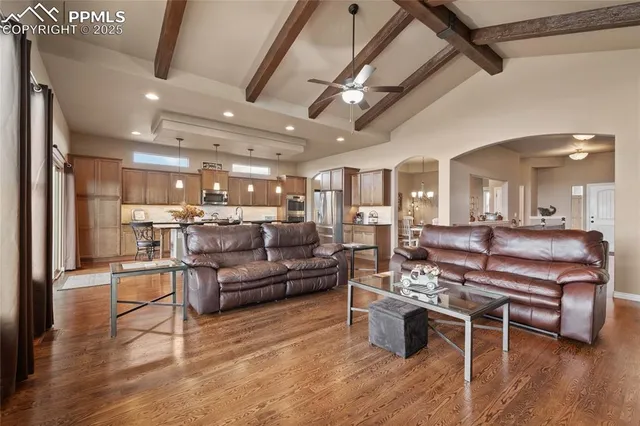 a kitchen with stainless steel appliances granite countertop a kitchen island a stove a table and chairs in it