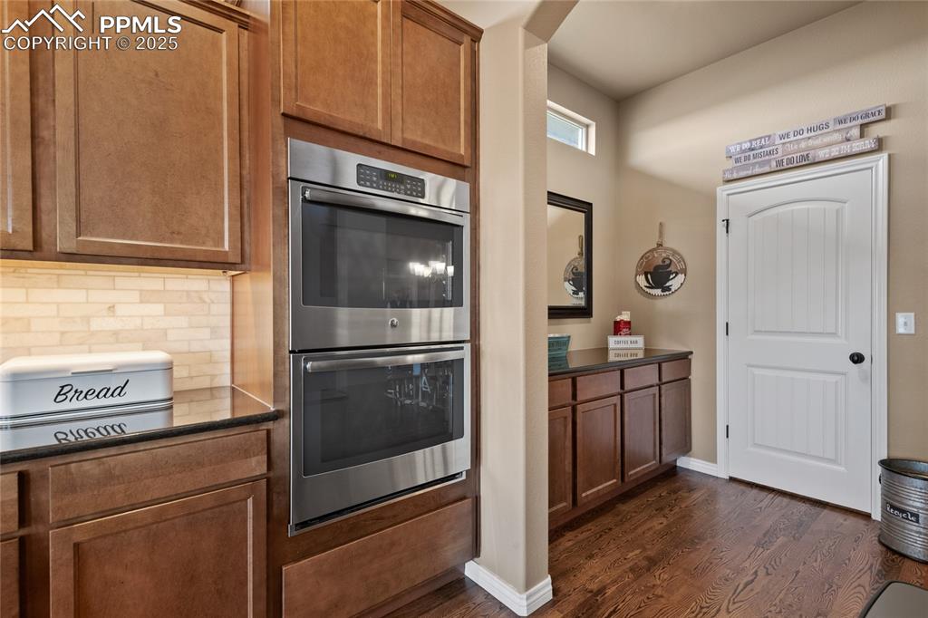 3718 Sky Rim Court Colorado Springs, CO 80908 - Photo 19 of 49 a kitchen with granite countertop stainless steel appliances and wooden cabinets