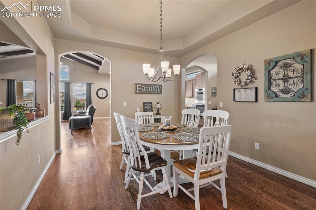 3718 Sky Rim Court Colorado Springs, CO 80908 - Photo 23 of 49 a view of a dining room with furniture window and wooden floor