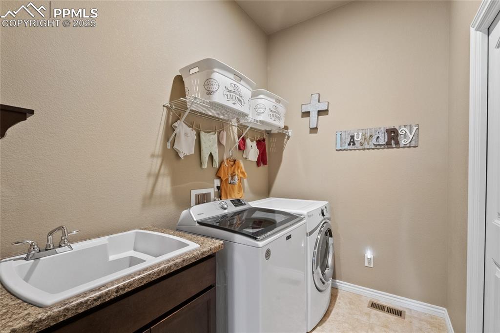 3718 Sky Rim Court Colorado Springs, CO 80908 - Photo 32 of 49 a utility room with dryer and washer