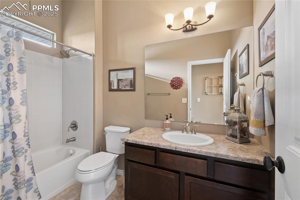 3718 Sky Rim Court Colorado Springs, CO 80908 - Photo 35 of 49 a bathroom with a granite countertop sink toilet and shower