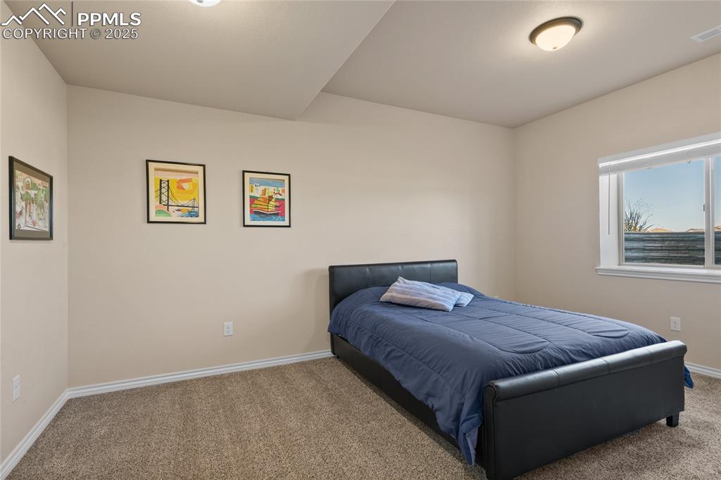 3718 Sky Rim Court Colorado Springs, CO 80908 - Photo 40 of 49 a living room with a bed furniture and painting on the wall