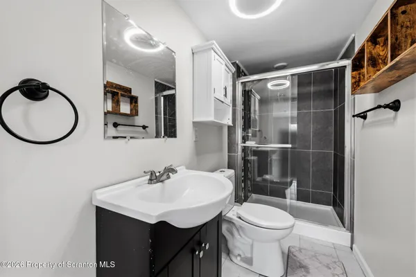 a bathroom with a sink toilet and a mirror