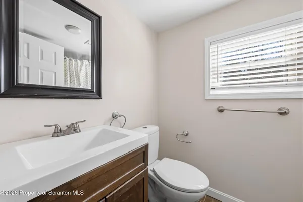 a bathroom with a sink a toilet and mirror