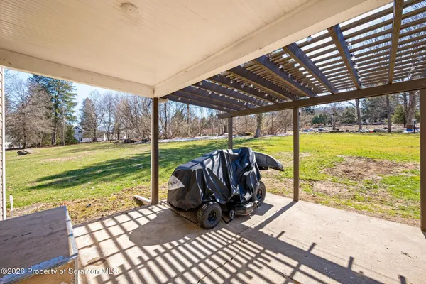 a view of a couches in patio with a yard