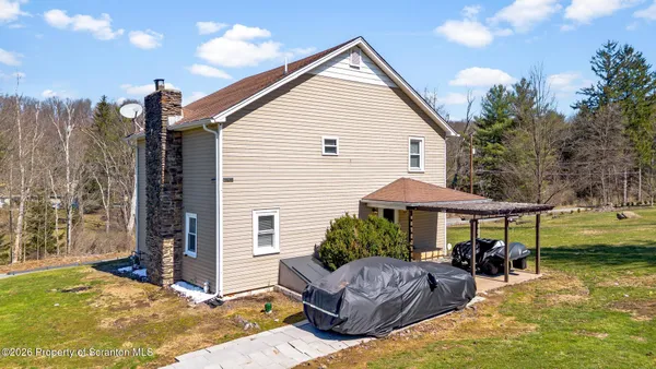 a view of a house with backyard and sitting area