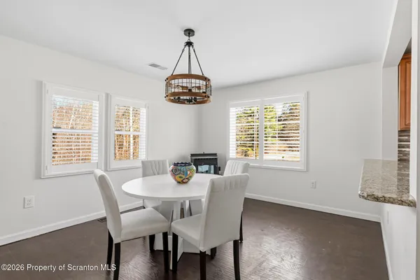 a view of a dining room with furniture windows and chandelier