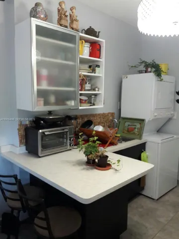 a kitchen with a table and chairs
