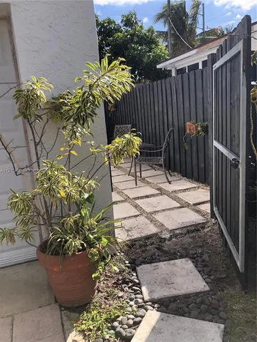 a view of a chairs and table in the backyard