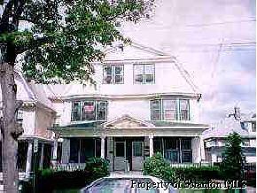 a front view of a residential apartment building with a yard