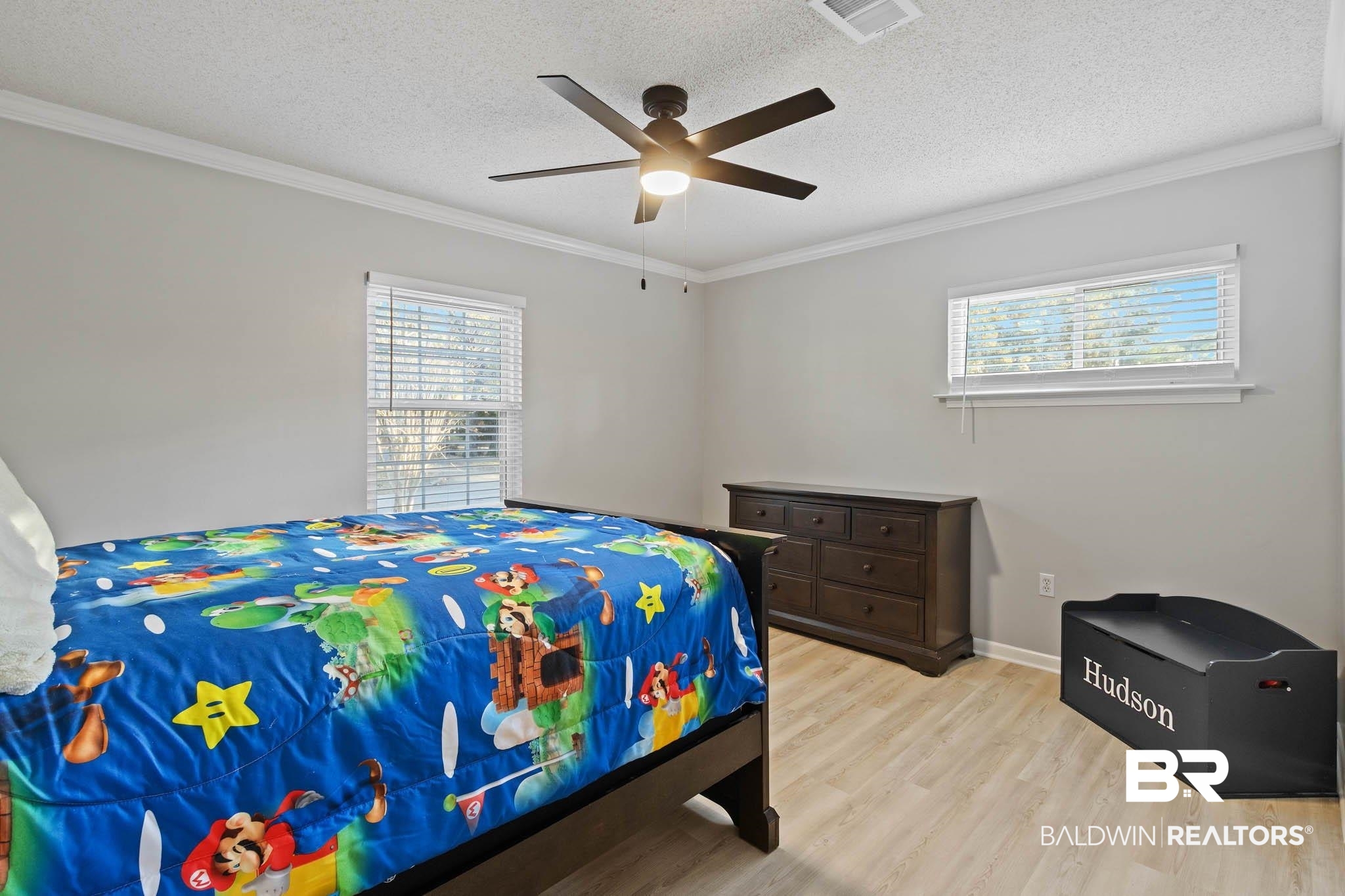 608 Southern Way Daphne, AL 36527 - Photo 27 of 35 Bedroom featuring crown molding, light wood-style floors, multiple windows, a textured ceiling, and ceiling fan