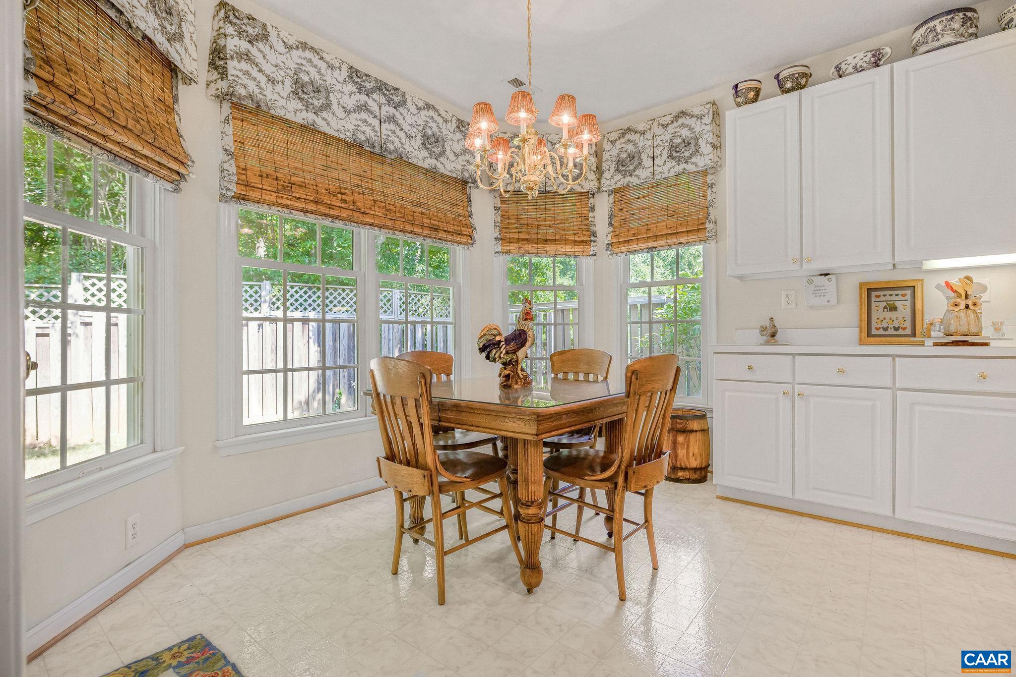 2111 Shepherds Ridge Road Charlottesville, VA 22901 - Photo 17 of 31 a dining room with furniture a chandelier and window
