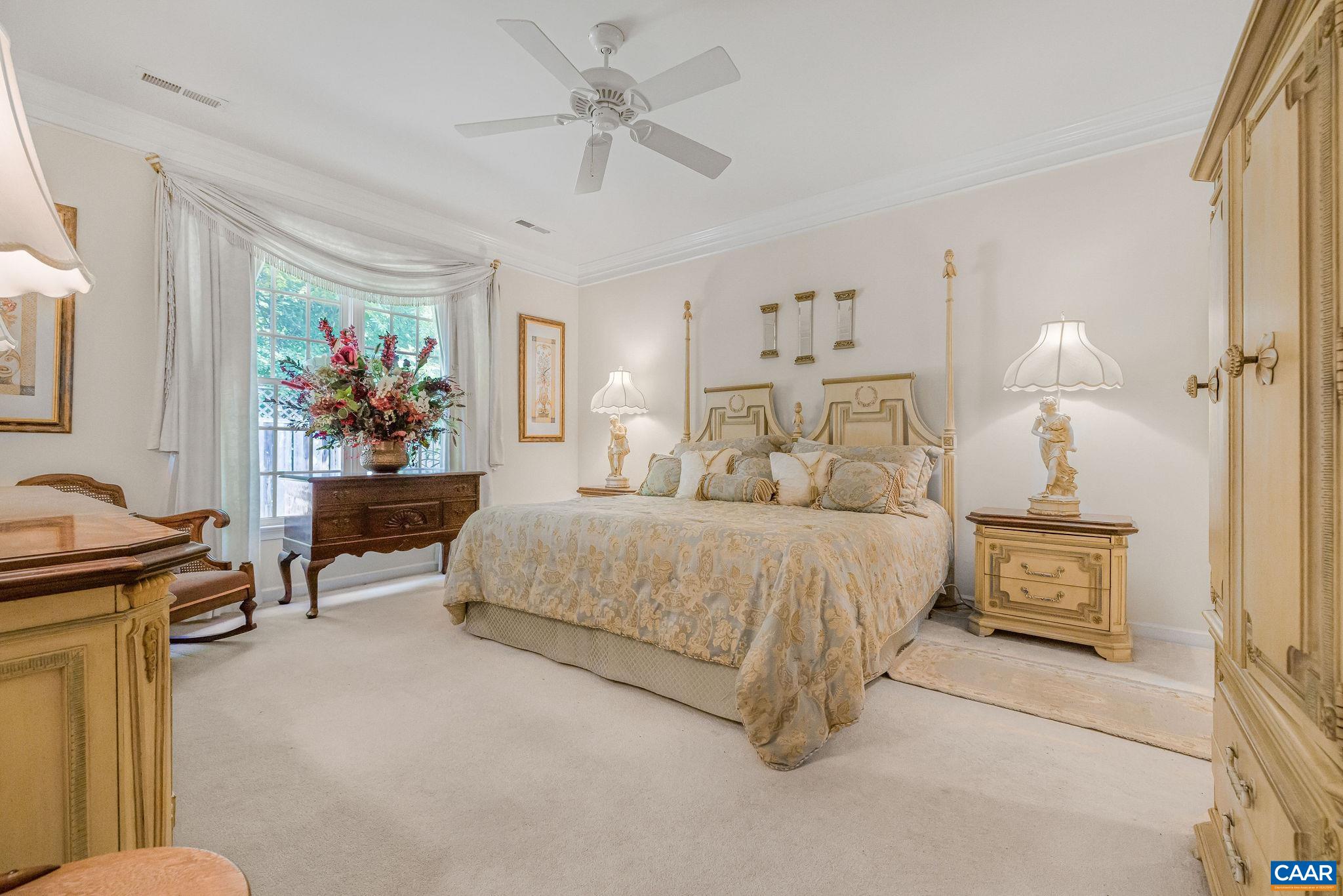 2111 Shepherds Ridge Road Charlottesville, VA 22901 - Photo 18 of 31 a spacious bedroom with a bed a couch and a chandelier