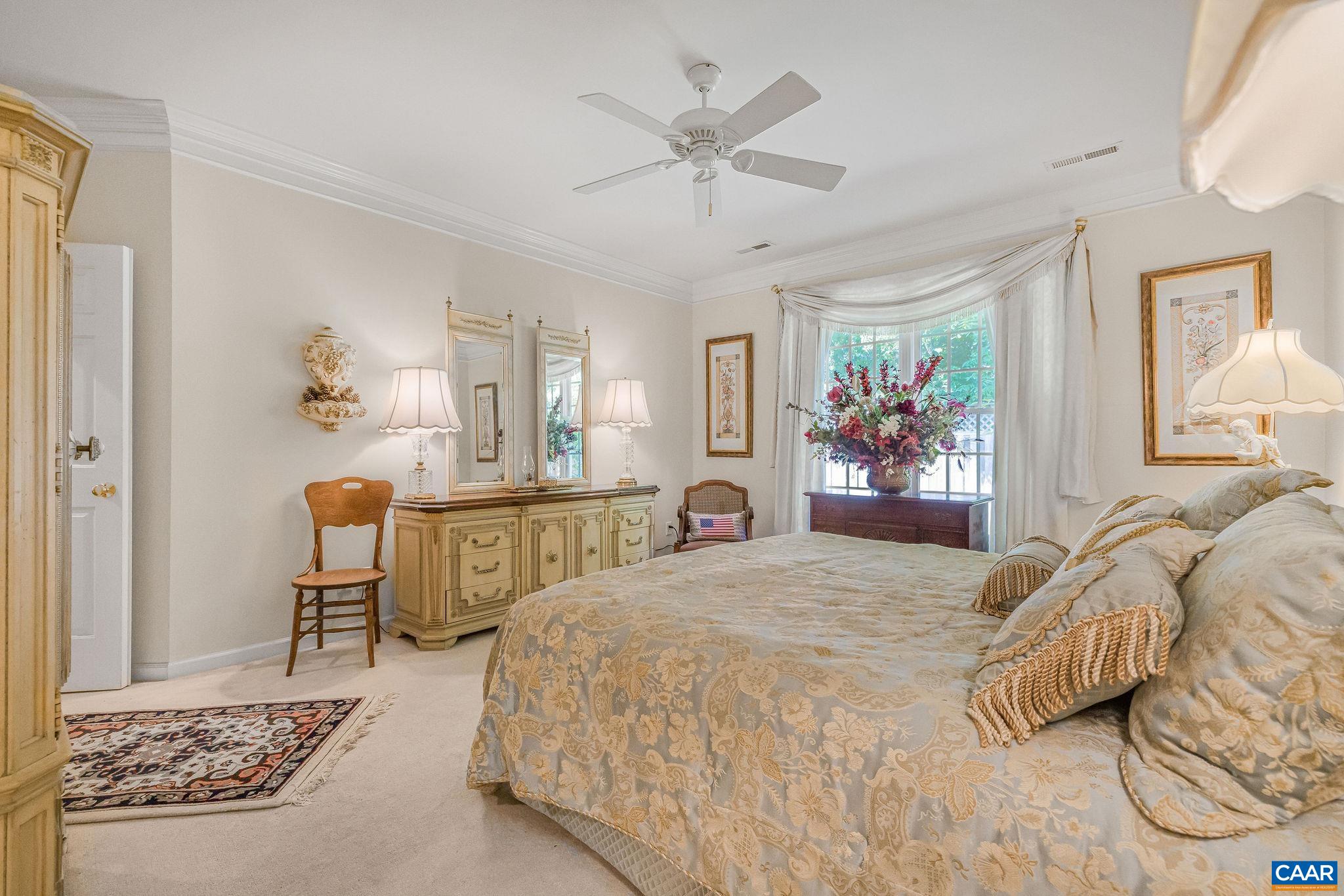 2111 Shepherds Ridge Road Charlottesville, VA 22901 - Photo 19 of 31 a bedroom with a large bed and a chandelier