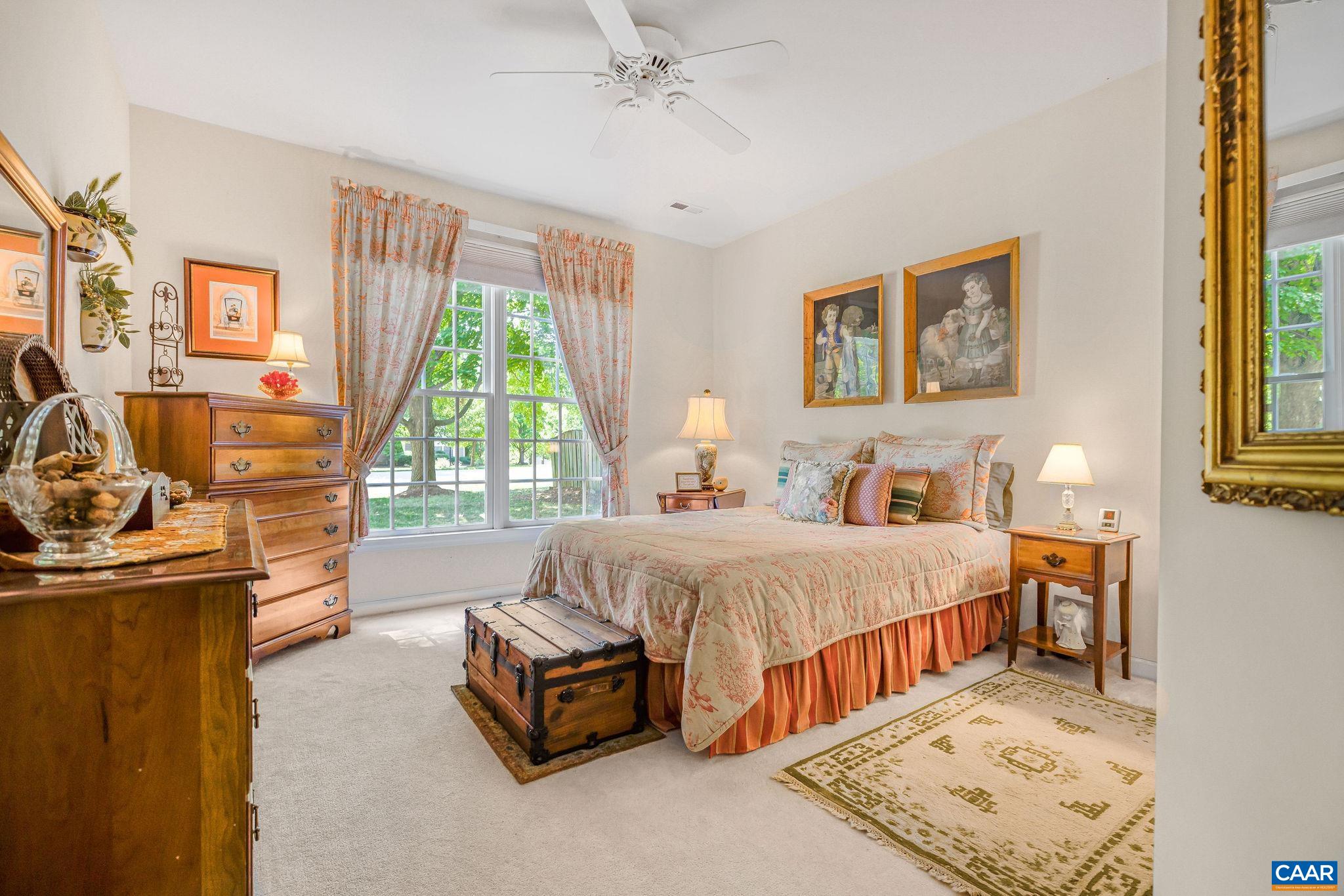 2111 Shepherds Ridge Road Charlottesville, VA 22901 - Photo 22 of 31 a spacious bedroom with a bed and a table