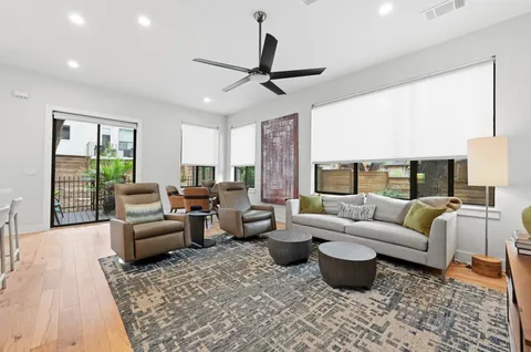 a living room with furniture ceiling fan and a rug