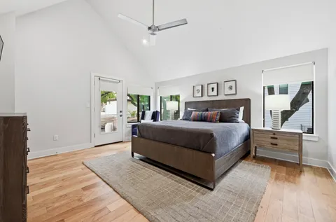 a bedroom with a large bed and a chandelier