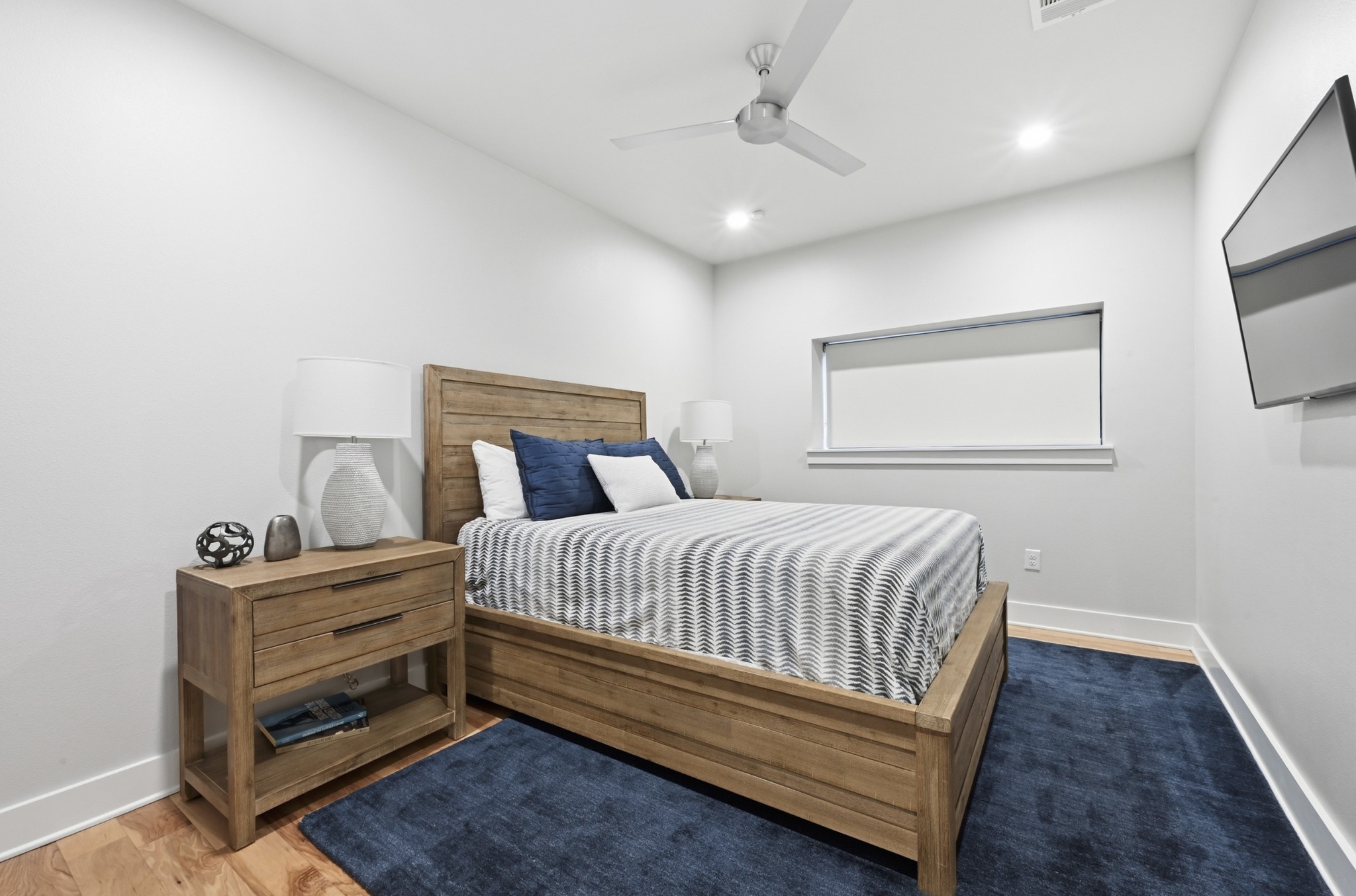3115 Clawson Road, Unit 201 Austin, TX 78704 - Photo 22 of 34 Light-filled bedroom featuring wood-finish flooring, a contemporary ceiling fan, recessed lighting, and a horizontal window with a roller shade