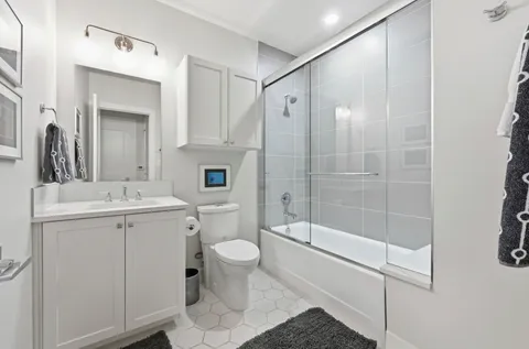 a bathroom with a sink toilet and shower