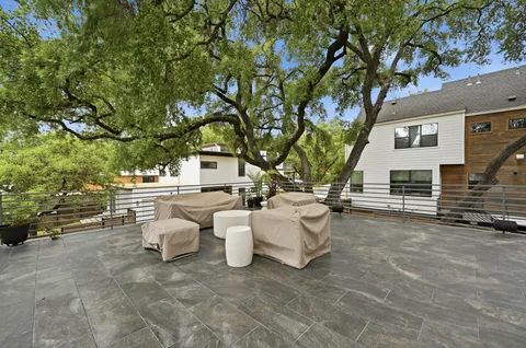 a view of a patio with table and chairs and couches