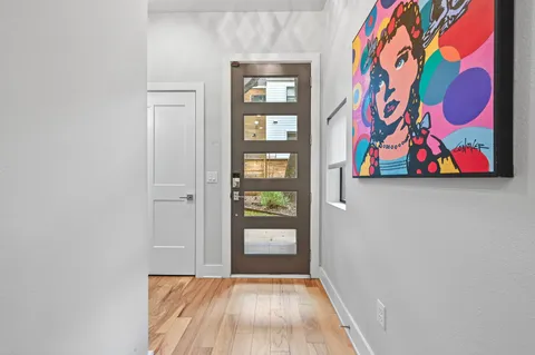 a view of front door with wooden floor