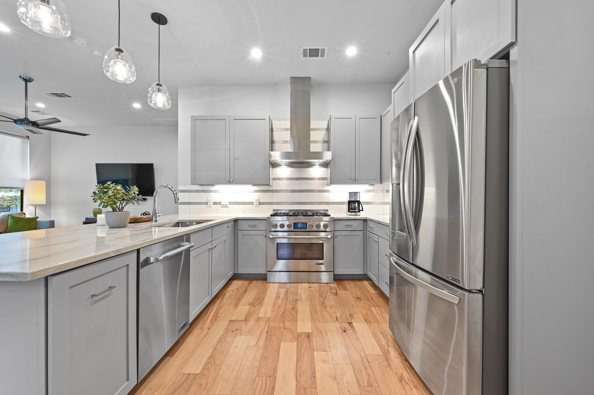 3115 Clawson Road, Unit 201 Austin, TX 78704 - Photo 9 of 38 a kitchen with stainless steel appliances a refrigerator sink and wooden floor