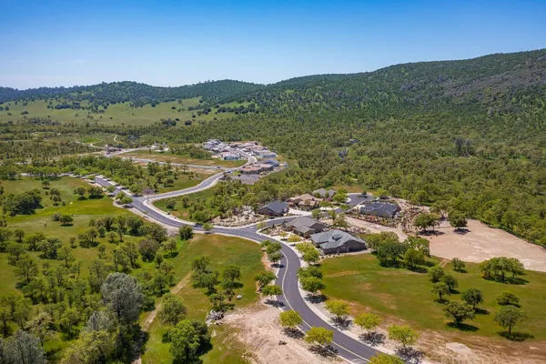 an aerial view of a house with a lake view