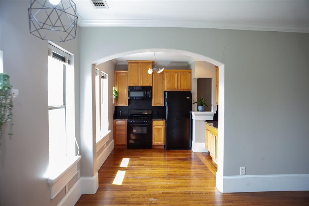 5347 Lewis Street, Unit 5345 Dallas, TX 75206 - Photo 11 of 37 The arched transom perfectly frames the fully equipped kitchen, complete with gas range, microwave and refrigerator.