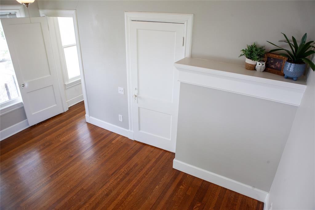 5347 Lewis Street, Unit 5345 Dallas, TX 75206 - Photo 16 of 37 The primary bedroom positively glows with original hardwoods, walk-in closet and decorator's dream shelf.